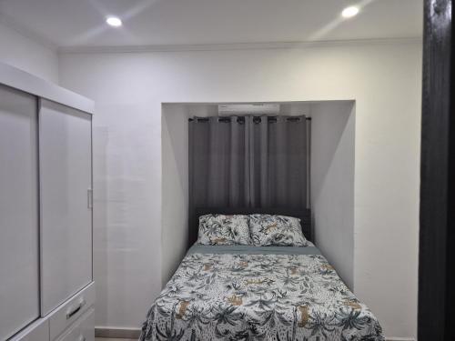 a bedroom with a bed in a white room at Island Ease Villa in Willemstad