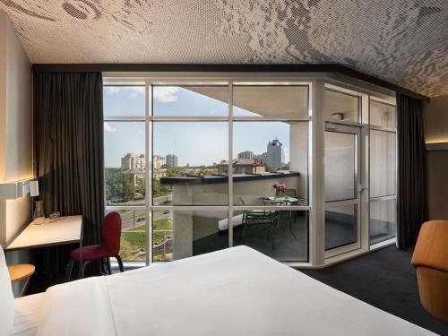 a hotel room with a bed and a large window at ibis Kyiv Beresteiska in Kyiv