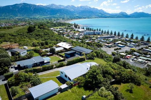 an aerial view of a small town next to the ocean at Expansive Views, Spacious, Large Yard - KK24113 in Kaikoura