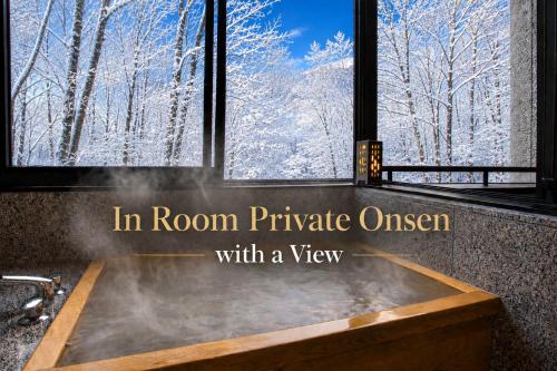 a bath tub in room private oasis with a view at Nakao Kogen Hotel Kazaguruma in Takayama
