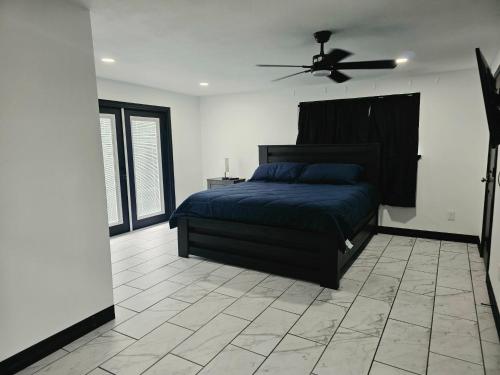 a bedroom with a bed and a ceiling fan at Alma House in Corpus Christi