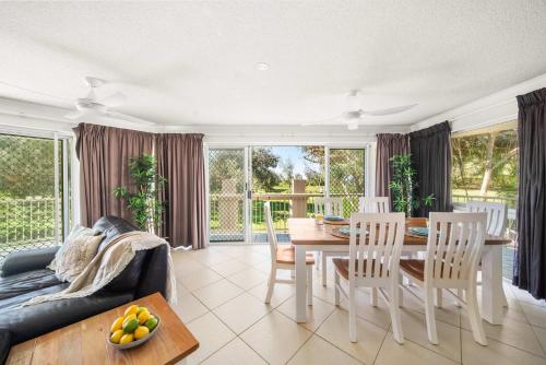 a living room with a table and chairs at Surfside Buddina Beachfront 3bed Apt - Direct Beach Access in Buddina