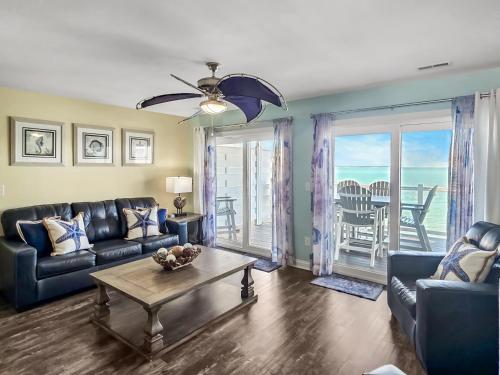 a living room with a couch and a table at Put-in-Bay Waterfront Condo #207 in Put-in-Bay