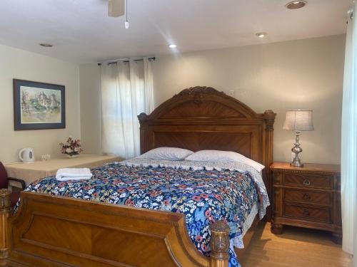a bedroom with a large bed with a wooden frame at WM Private master suite with separate entry in San Jose