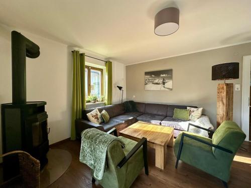 a living room with a couch and a table at Chalet with Mountain View in Piesendorf