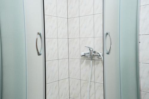 a shower door with a sink in a bathroom at Villa Grubešić - Sea View Apartments in Kustići