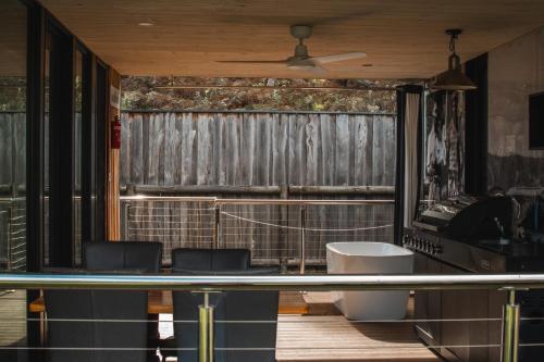 a room with two chairs and a tennis court at Softfoot Farm Luxury Retreats in Hindmarsh Valley