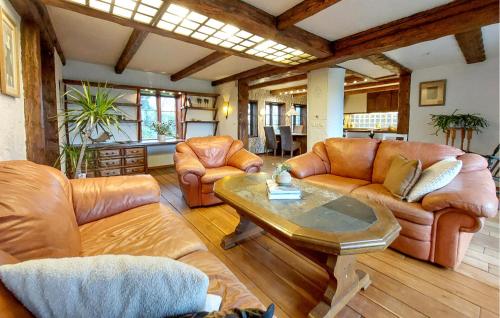 a living room with leather furniture and a table at Villa Kalle in Åstorp