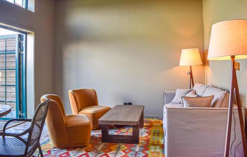 a living room with a couch and chairs and a table at Beautiful Home In Kivik in Kivik