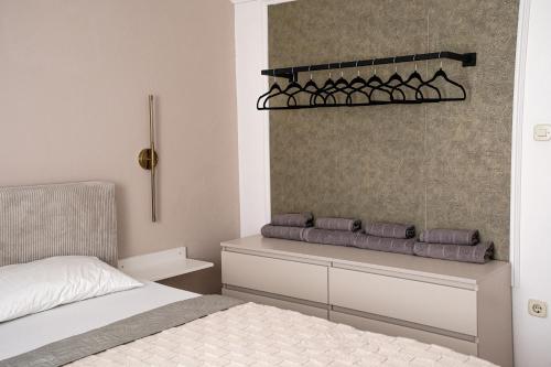 a bedroom with a bed and a shelf with pillows at Villa Grubešić - Sea View Apartments in Kustići