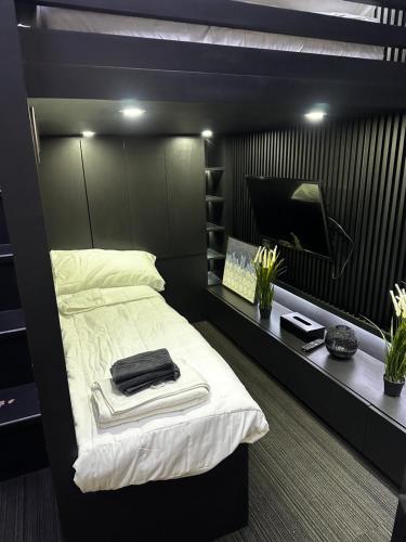 a bedroom with a large bed with a television at Cloud & Rey condo rentals in Roxas City