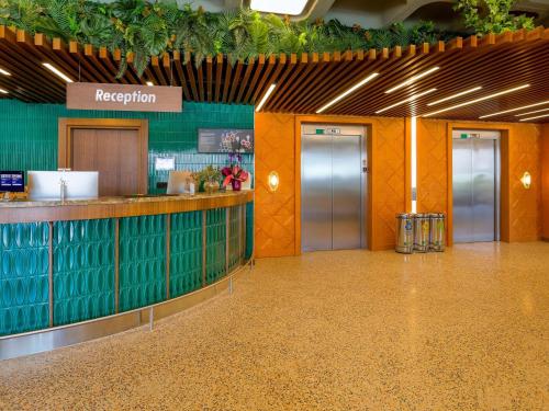 a lobby of an airport with a reception counter at ibis Styles Istanbul Kurtkoy in Istanbul