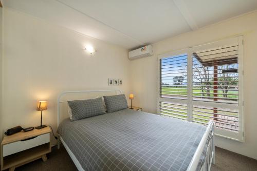 a bedroom with a bed and a window at Nathan's Place in Whitfield