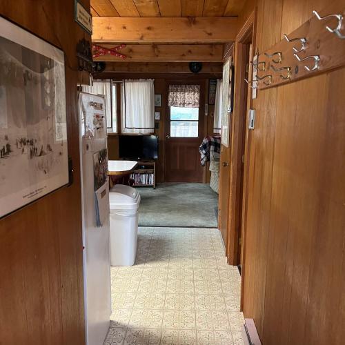 a hallway of a house with a refrigerator at Adorable Aframe in the White Mountains in Conway