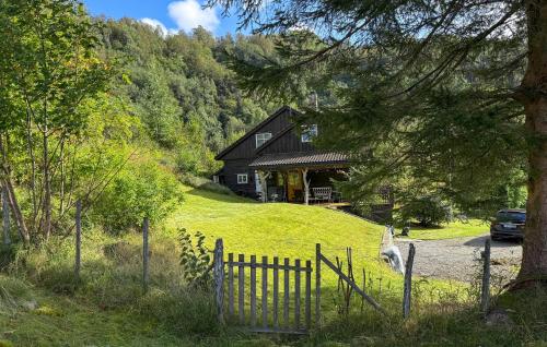 a house on a hill with a fence in front of it at 5 Bedroom Amazing Home In Matre in Bauge