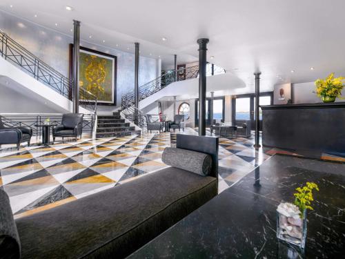 a living room with a couch and a staircase at Mövenpick MS Sunray in Luxor