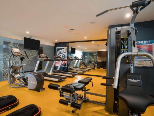 a gym with several treadmills and cardio equipment at ibis Styles Kuala Lumpur Bukit Bintang in Kuala Lumpur