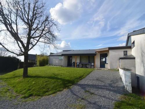 a house with a tree in the yard at Sunny Cottage with Pool in Purnode