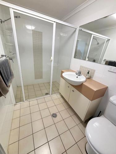 a bathroom with a shower and a sink and a toilet at Jubilee Apartment 06 in South West Rocks