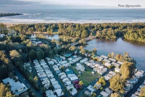 an aerial view of a parking lot next to the water at Discovery Parks - Gerroa in Gerroa