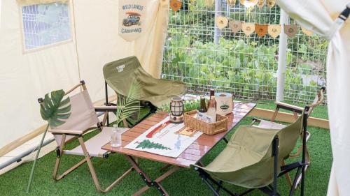 a table and two chairs and a table and a table and chairs at Gapyeong Jmong Choncance&Camping Pension in Gapyeong