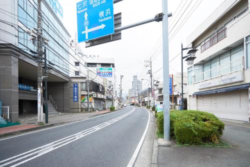 an empty street in a city with buildings at Hotel Select Inn Isehara in Isehara
