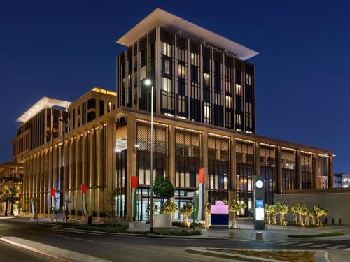 a large building on a city street at night at Mercure Dubai Gold District in Dubai
