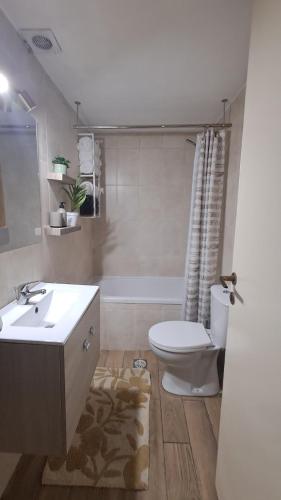 a bathroom with a white sink and a toilet at The Village Retreat in Malona Village
