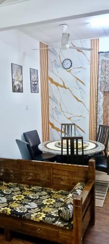 a living room with a table and chairs in a room at Shayus Homestay in Kampong Alor