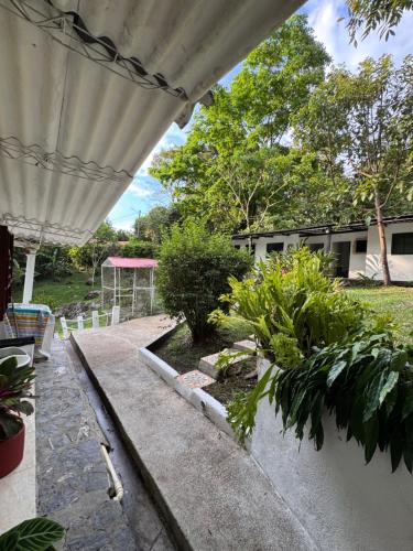 a view of a garden from the porch of a house at Villa Nacha in Villeta