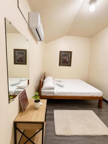 a small room with a bed and a mirror at Bayay Isla Inn in General Luna