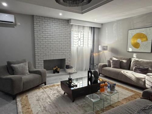 a living room with a couch and a fireplace at The Hill Manor in Ndola