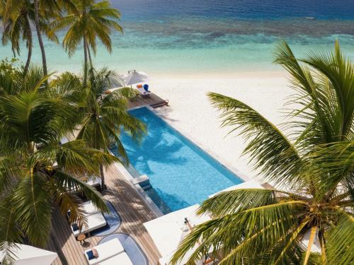 an overhead view of a swimming pool next to a beach at V Villas Maldives at Mirihi - MGallery Collection in Mandhoo