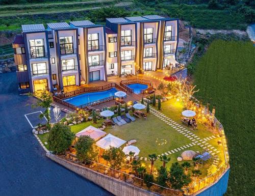 an aerial view of a building with a swimming pool at Stonecove Pension in Geoje