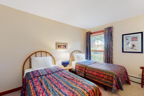 a hotel room with two beds and a window at Trail Creek 75 in Killington
