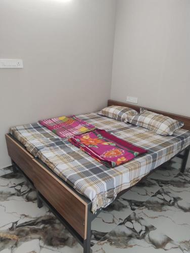 a bed with a quilt on top of it at DRK Luxury Stays in Siruseri