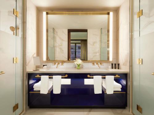 a bathroom with a sink and a mirror at Hard Rock Hotel New York - Partner of ALL Accor in New York