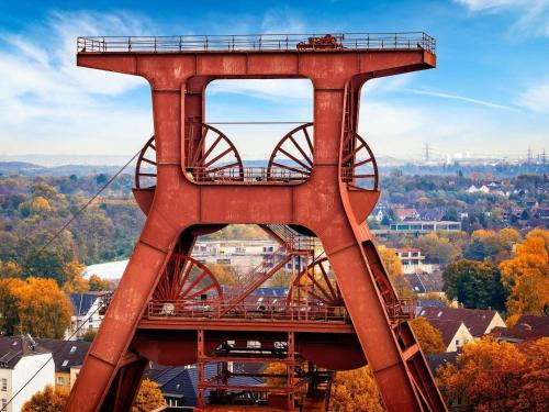 a tall red bridge with a train on it at Webers Hotel im Ruhrturm Essen by Accor in Essen