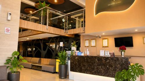 a lobby with a waiting area with couches and a tv at Vio Hotel Pasteur in Bandung
