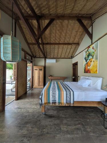 a bedroom with a large bed in a room at Meno Lagoon Bungalows in Gili Meno