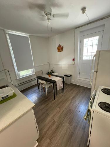 a kitchen with a table and a dining room at City Centre Suite, Steps to UofT, TMU, Yonge-Dundas Square in Toronto