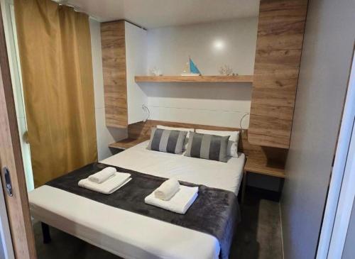 a bedroom with a bed with two towels on it at Holiday Homes Lavanda - Biograd na Moru in Biograd na Moru