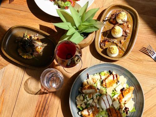 a table with three plates of food and a glass of wine at ibis Styles Avignon Sud in Avignon