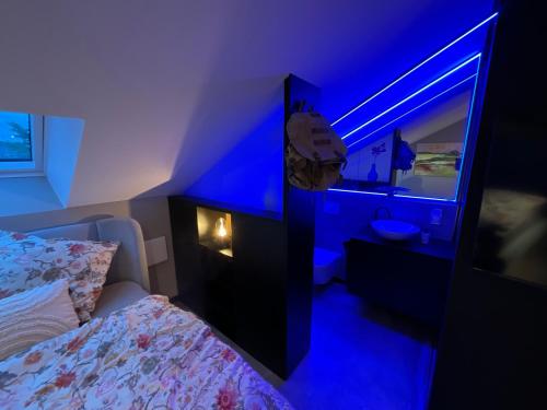 a bedroom with a bed and a blue light at Gleisbett 12-1 in Meiningen