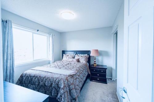 a bedroom with a bed and a window at Cozy Prairie Mansion in Winnipeg