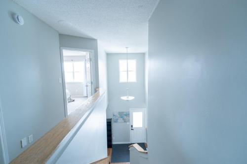 a living room with blue walls and a hallway at Cozy Prairie Mansion in Winnipeg