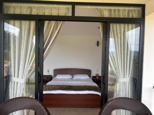 a bedroom with a bed and two chairs at Annfield Cabana in Hatton