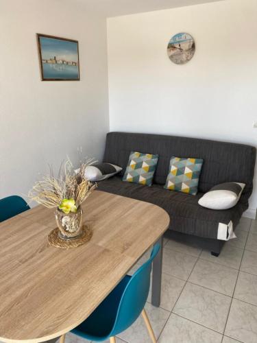 a living room with a table and a couch at comfort and breathtaking view in Frontignan