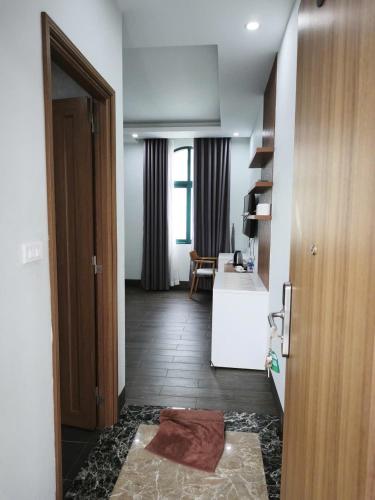 a room with a kitchen and a hallway with a door at Kakashi Hotel Phú Quốc in Phú Quốc