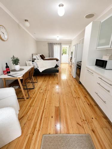 a living room with a couch and a table at Verandah Suite in Seacliff